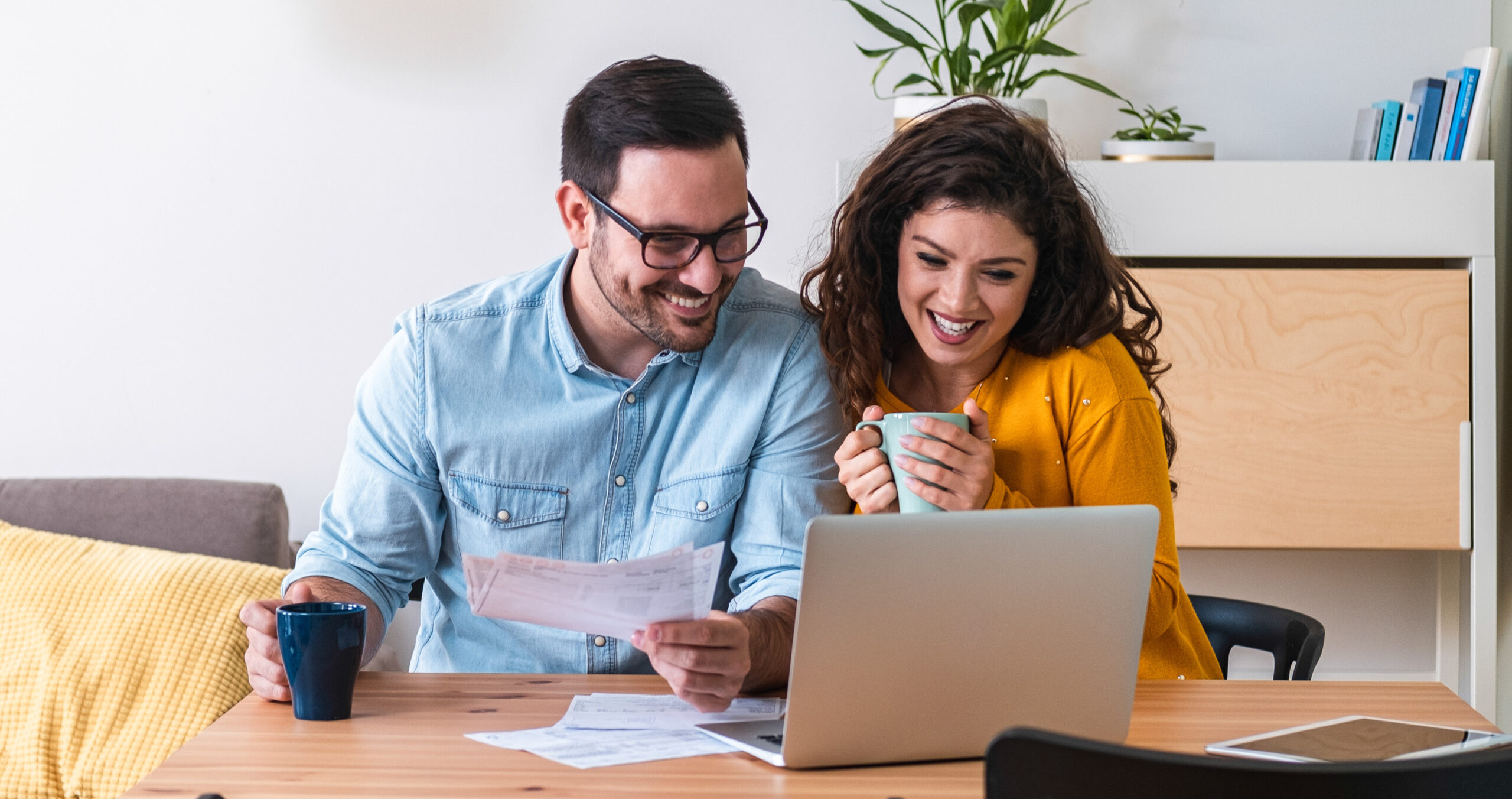 Couple filling our mortgage application on laptop