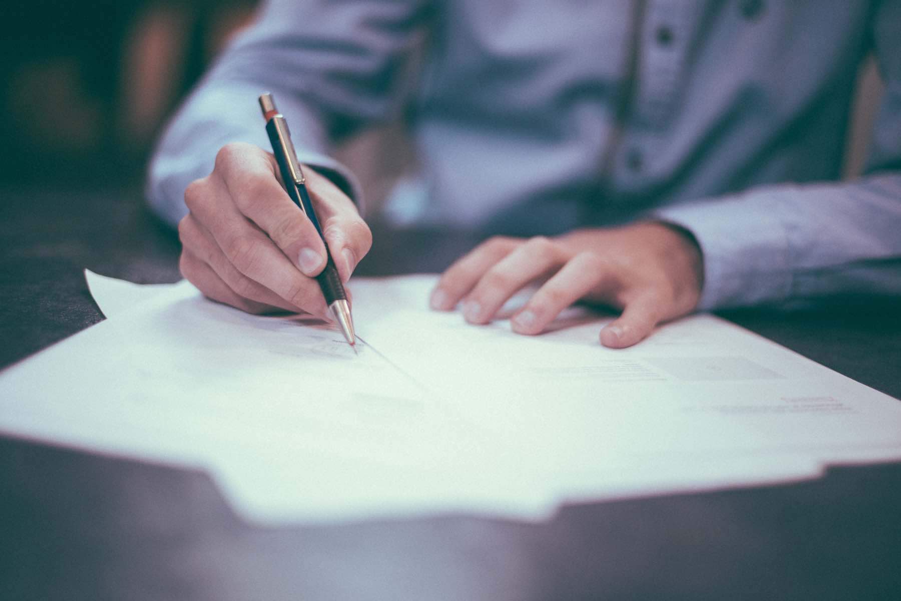 Man signing legal documentation