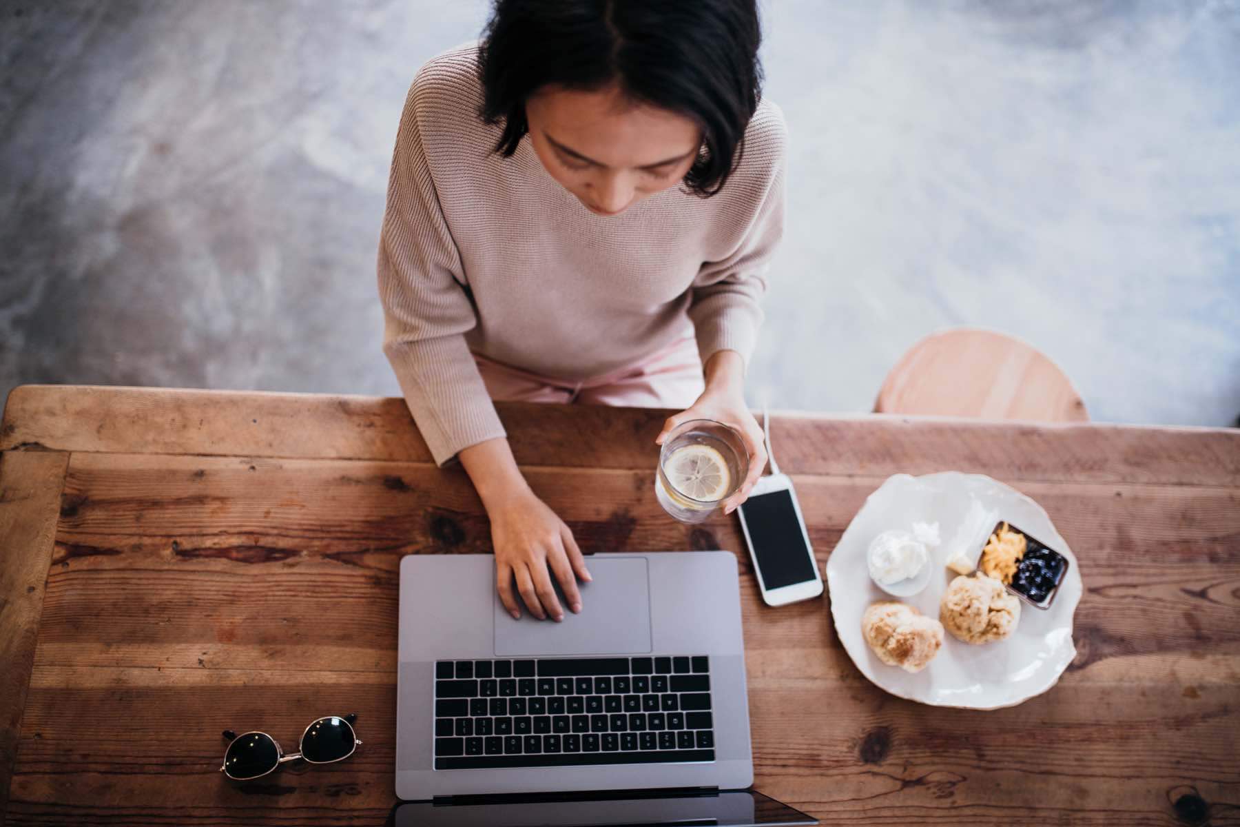 Woman in a coffee shop looking for a mortgage online
