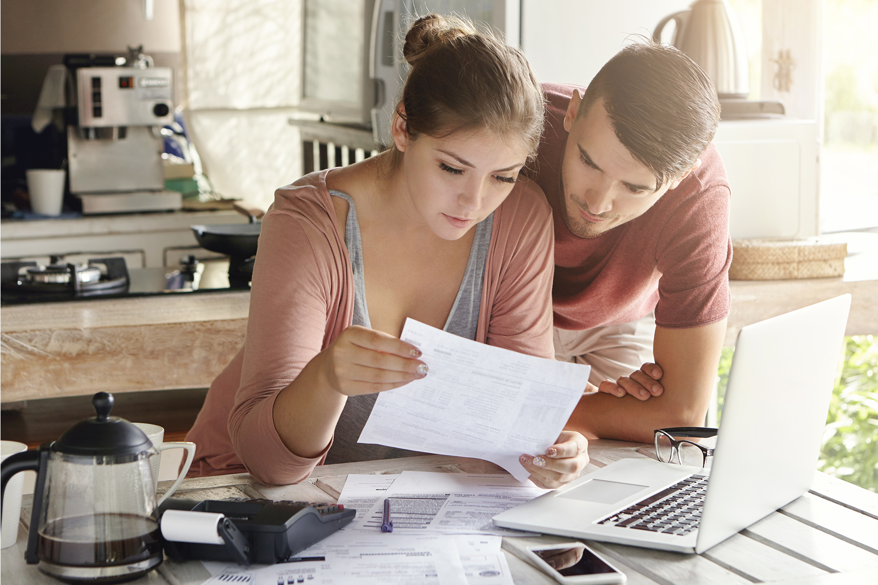 Young man and woman at a table looking at financial statements