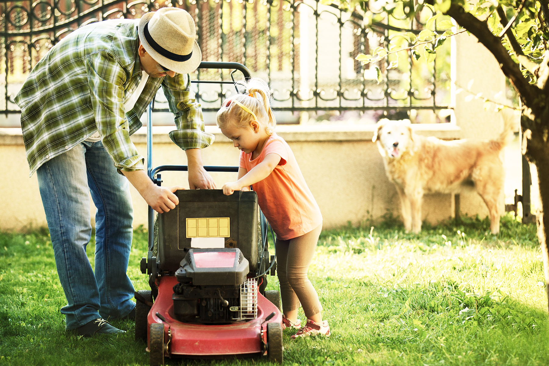Father and daughter in yard during summer