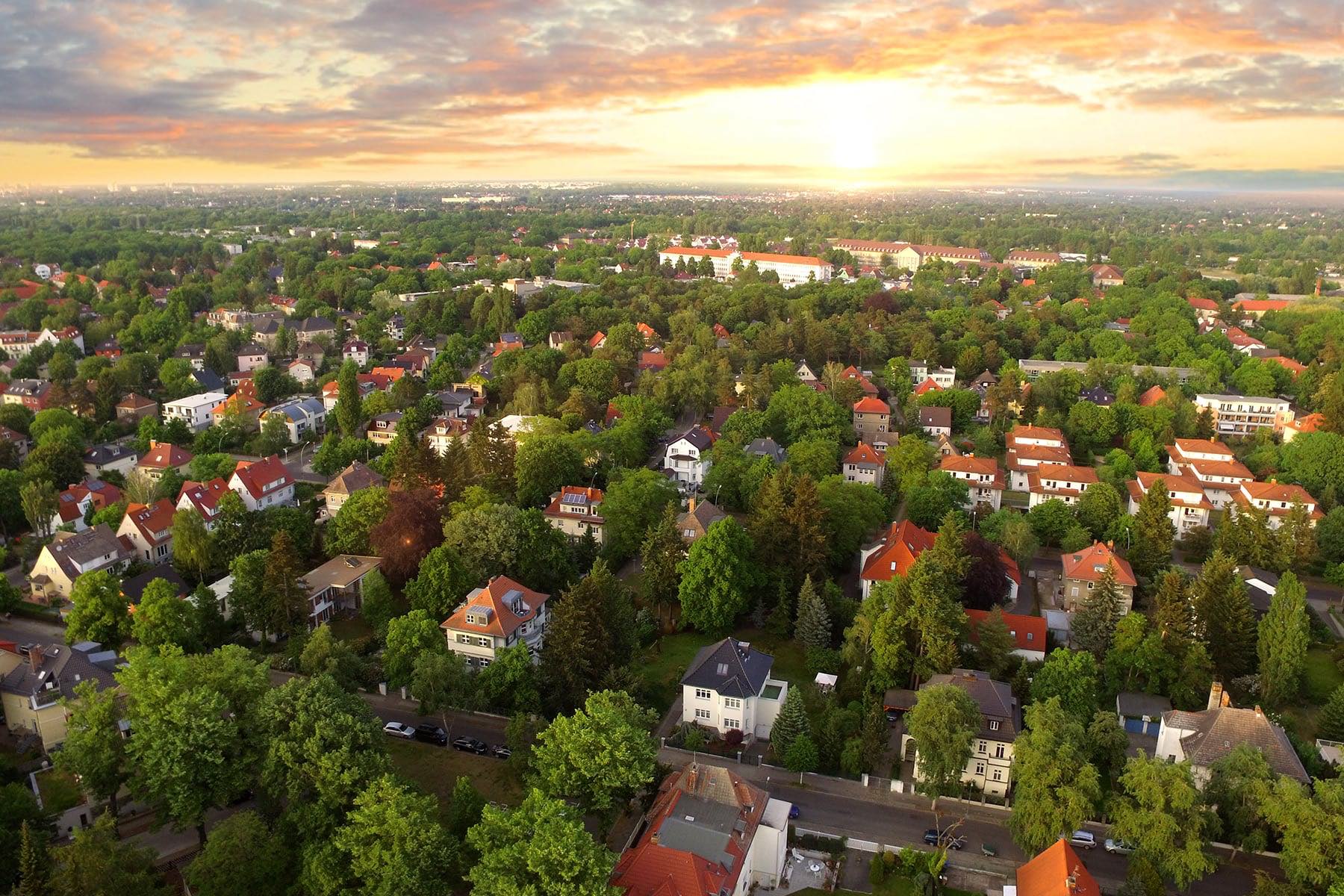 Feature image for How Local Lenders Give You An Edge In A Hot Housing Market blog post - suburban neighborhood at sunset