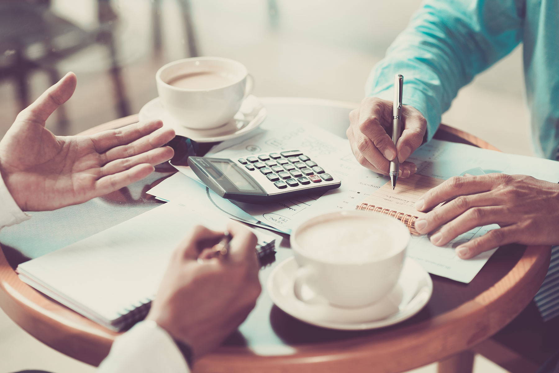 two men discussing finances over coffee