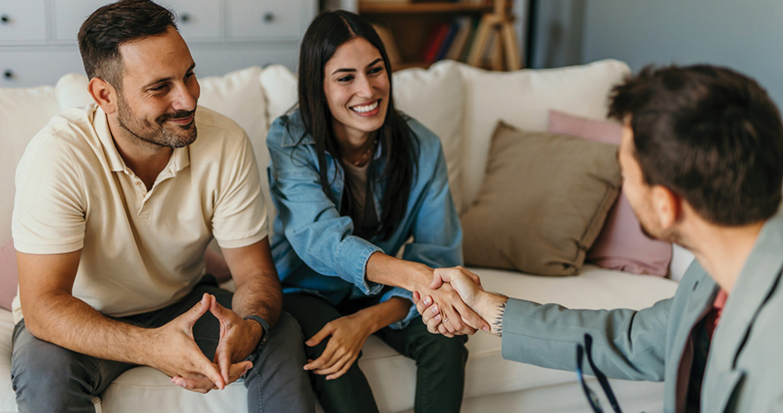 Couple buying a home and locking in their interest rate with their mortgage lender.