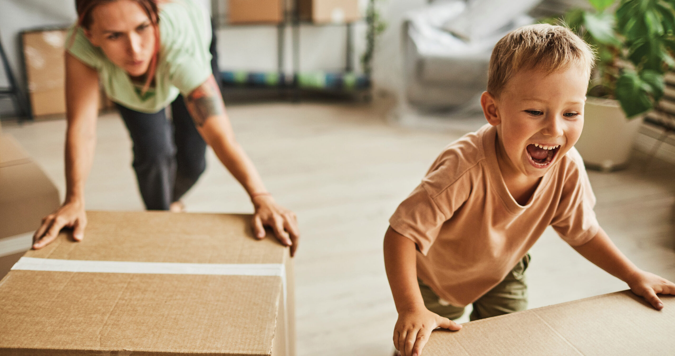 Family Moving Boxes Into New Home